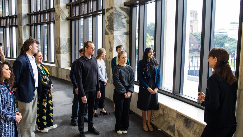 Visitors on a tour looking out over Wellington from inside Parliament